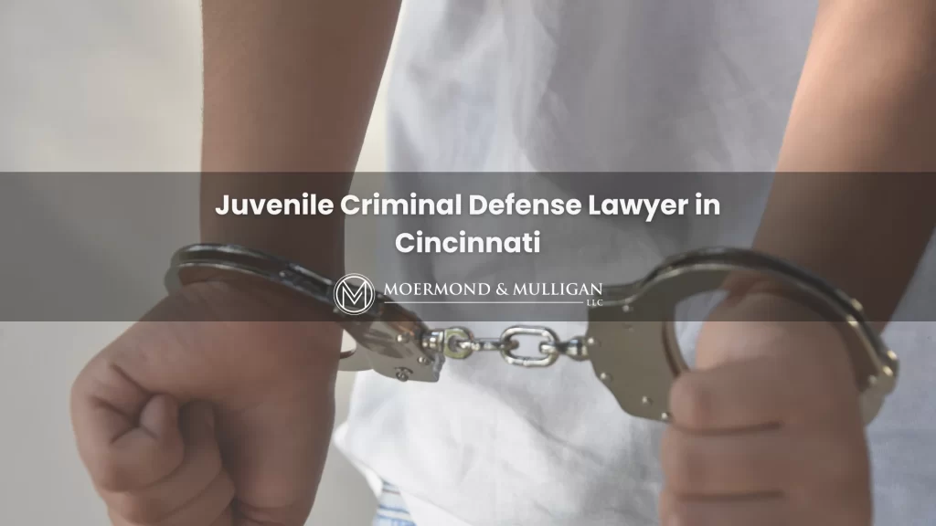 Closeup of hands in handcuffs behind the back with superimposed words: Juvenile Criminal Defense Lawyer in Cincinnati.
